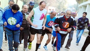Athletes sweating-it-out during Veteran Athletic Meet In Jammu on Monday.
