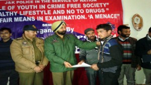 Chief guest J S Johar felicitating winners of symposium at Govt Degree College, Mendhar in Poonch on Thursday.