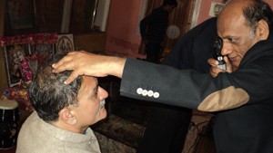 A doctor examining the eyes of a patient during an eye camp at Trikuta Nagar in Jammu.
