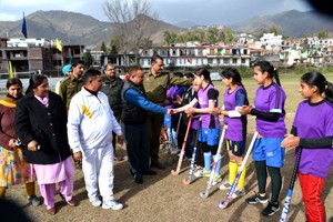 Chief guest interacting with the players during hockey match organized under CAP at Sports Stadium in Poonch on Friday.  