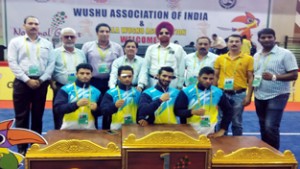 Wushu gold medallist Bhanu Pratap and other players posing along with chef-de-mission, HS Gill and other dignitaries at Thriruvananthapuram in Kerala on Friday.