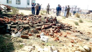 Structure rebuild on forest land at Sunjwan again smashed by joint team of Police & Forest Department on Friday.