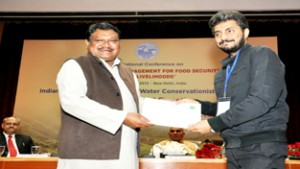 Dr Vivak M Arya receiving award from Jual Oram, Union Minister of Tribal Affairs in New Delhi on Wednesday.