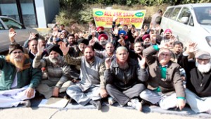 VRS employees sitting on dharna against State SRTC in front of Press Club, Jammu. -Excelsior/Rakesh