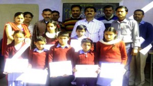 Winners of symposium posing along with dignitaries at MS Badhal in Udhampur.  