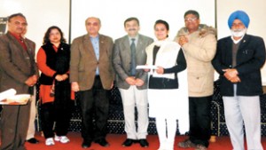 Winner being felicitated by the dignitaries during a symposium at GDC Udhampur.