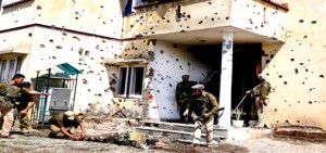 Body of slain militant lying in front of extensively damaged Rajbagh police station on Friday. -Excelsior/Rakesh