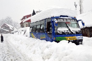 A bus trapped in heavy snow in Kashmir on Monday. — Excelsior/ Sajjad Dar