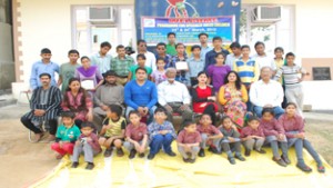 Specially abled children posing for a group photograph along with dignitaries after the prize distribution function in Jammu.