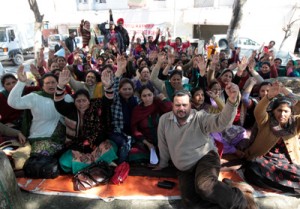 FMPHWs staging protest outside Director’s office in Jammu on Friday. -Excelsior/Rakesh