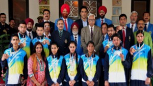 Medal winners of 35th National Games posing alongwith Governor N N Vohra during felicitation function at Raj Bhawan in Jammu on Thursday.