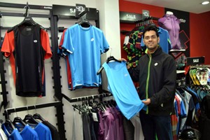 A salesman showcasing Running and Tennis apparel of Lotto’s Spring Summer Collection at Jammu.