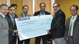 Country Head HDFC Bank Ltd Abhay Aima presenting cheque to Minister for Finance Dr Haseeb Drabu.