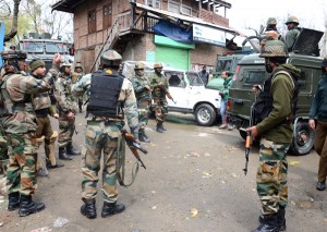 Troops take positions during encounter with militants at Tangmarg in Baramulla on Thursday. — Excelsior/Amin War