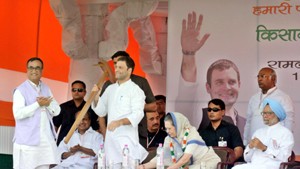 Congress vice president Rahul Gandhi being presented a plough  at a farmers rally in protest against the Land Acquisition Bill at Ramlila Maidan in New Delhi on Sunday. (UNI)