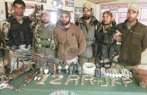 Security personnel pose with arms and ammunition seized in Banihal on Tuesday.