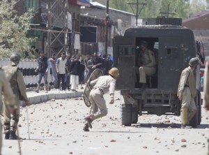 Protesters throw stones at police during a protest in Narbal area of Budgam district on Saturday. -Excelsior/Amin War