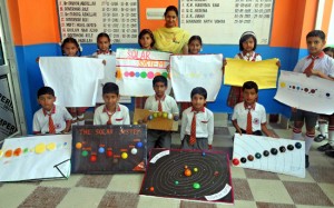 Winners of Science model competition displaying certificates while posing for a group photograph.