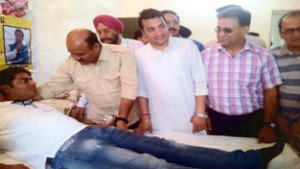 A youth donating blood at Trikuta Nagar on Sunday.