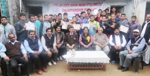 Wrestlers posing along with dignitaries during the concluding function of 7th State Wrestling Championship in Jammu on Wednesday.