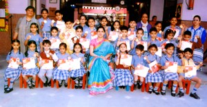 Meritorious Jr wing students posing for a group photograph along with Headmistress Sofia Rana at KC Public School in Jammu on Thursday.