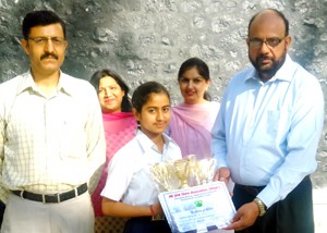 Principal BSF School, Dr S S Khokhar felicitating Arushi Kotwal on Friday.