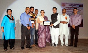 MLA Nowshera, Ravinder Raina presenting award during a function at Jammu on Sunday.