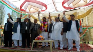PCC president GA Mir flanked by other party leaders waving to workers during convention at Anantnag on Sunday. —Excelsior/Sajad Dar