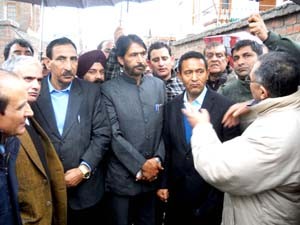 JKPCC president GA Mir interacting with people affected due to incessant rains at Srinagar on Wednesday.