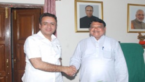Minister for CAPD, Ch. Zulfkar Ali and Union Minister for Tribal Affairs shaking hands.