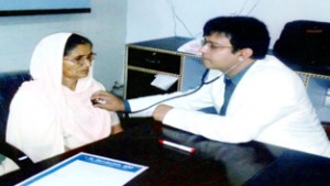 A senior doctor examining a patient during a free medical camp.