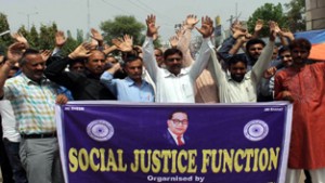 Members of SC/ST Organisation holding protest against recruitment policy at Jammu on Tuesday.