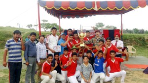 Winners posing for a group photograph along with the dignitaries after clinching title trophy at APS Akhnoor in Jammu on Wednesday.