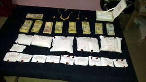 Cash and heroin packets recovered by police at the behest of smuggler in Akhnoor on Thursday.