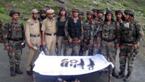 Army and police personnel pose with recoveries at Chasana in Reasi district on Wednesday.