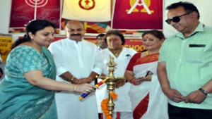 Minister of State for Education Priya Sethi lighting ceremonial lamp while inaugurating Investiture Ceremony at Alexander Memorial School in Jammu.