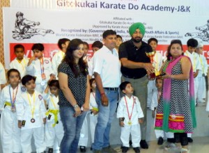 Karatekas of Kidzee posing along with dignitaries in Jammu.