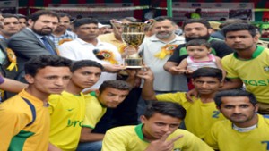Young footballers posing alongwith Minister for Sports, Imran Raza Ansari and other dignitaries during inaugural function of Sheikh-ul-Alam Knockout Football tournament in Srinagar.