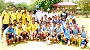 Young footballers posing along with officers and officials in Jammu on Thursday.