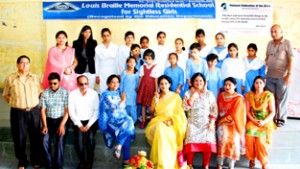 Special children posing for a group photograph alongwith chairperson PWWA, K Vijaya Rajendra in Jammu on Thursday.