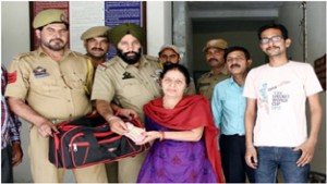 GRP Jammu men presenting lost bag to its actual owner.