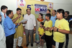 MP Jugal Kishore Sharma asking queries to UCMAS abacus students during 5th State Level Competition at Jammu on Sunday.