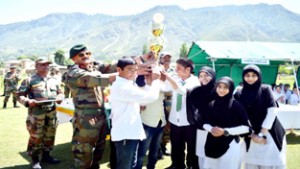 GOC Delta Force awarding overall best School trophy to Furqan Academy Kishtwar on Wednesday.