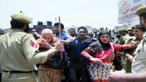 State Govt employees being baton-charged by police during protest in Srinagar on Thursday.— Excelsior/ Amin War