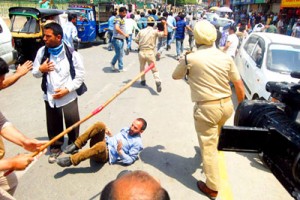 Agitating employees being canecharged in Srinagar on Thursday.