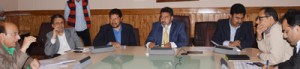 Minister for R&B, Syed Mohammad Altaf Bukhari chairing a meeting at Srinagar on Monday. 