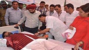 Health Minister Lal Singh donating blood on Sunday.
