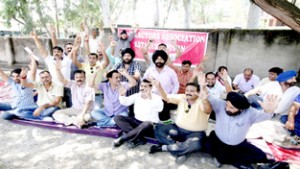 Contractors of Estates Division Jammu sitting on protest dharna at Jammu on Thursday. -Excelsior/Rakesh