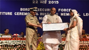 Home Minister Rajnath Singh presenting cheque to family member of a martyr during 13th BSF Investiture Ceremony.