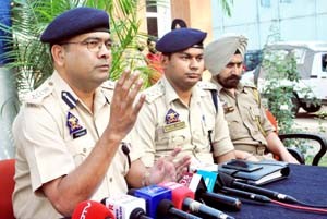 SSP Jammu Uttam Chand interacting with media persons at Jammu on Monday. SP South Sachin Gupta and SHO Gandhi Nagar Inspector Paramjit Singh also seen in the picture.